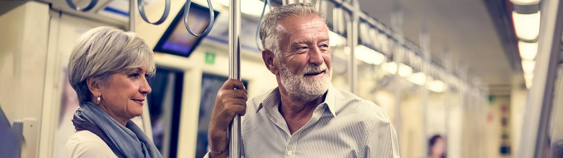 Image of two seniors on public transportation