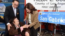 Image of elderly woman in a wheel chair shaking hands with another woman Image of elderly woman in a wheel chair shaking hands with another woman